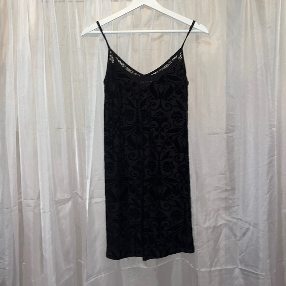 Black velvet patterned spaghetti strap dress with lace detail at top.